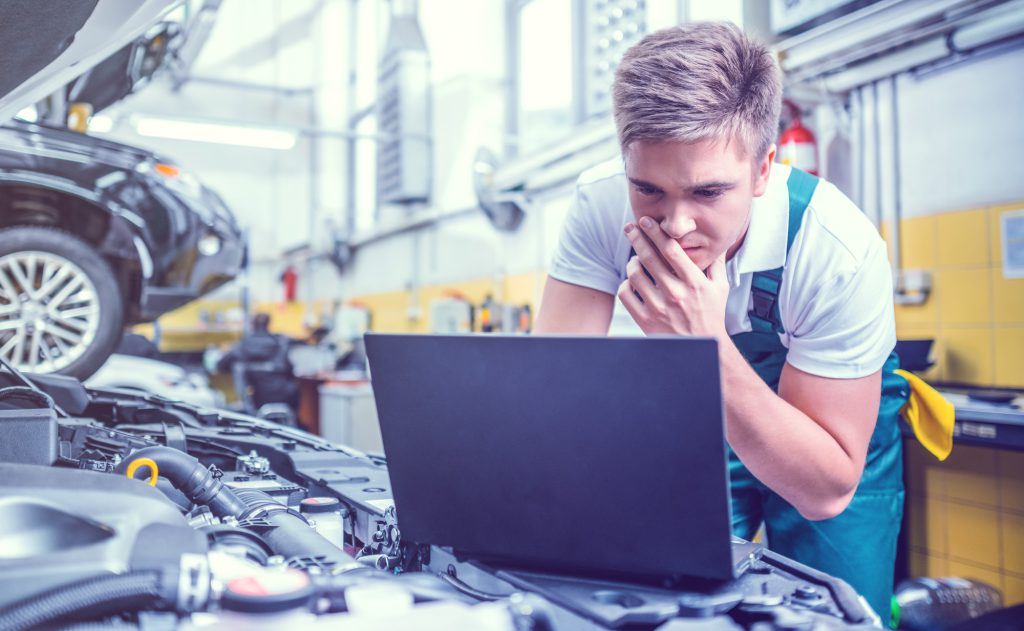 Mechanic checking a computer during a diagnostics inspection - Car Diagnostics Thirsk