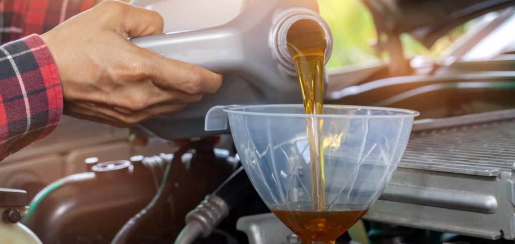 Mechanic pouring engine oil into a vehicle - Car Servicing Thirsk