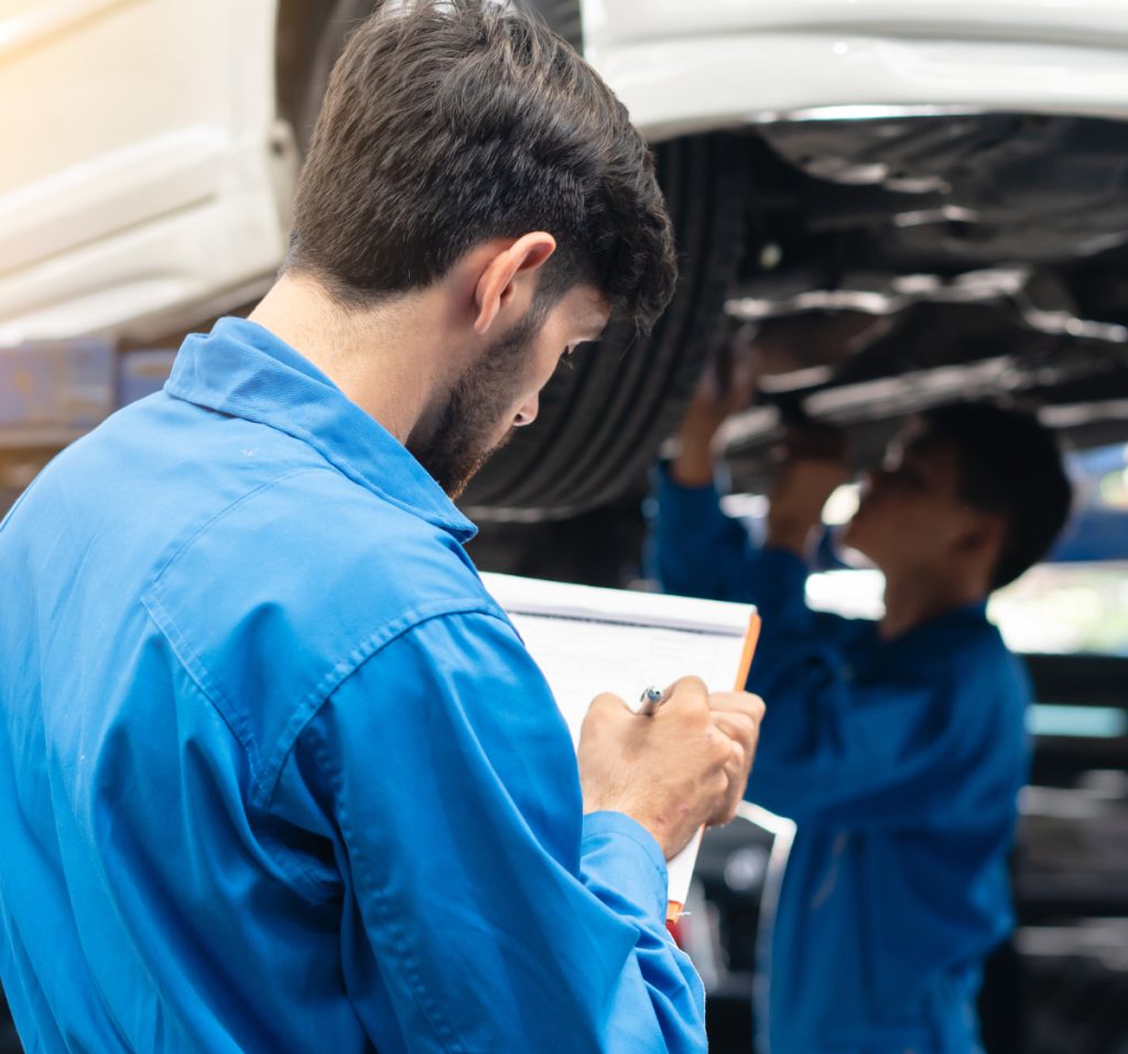 Two mechanics inspecting a vehicle - Car Servicing, MOTs, Repairs in Ely with Diamond Vehicle Services